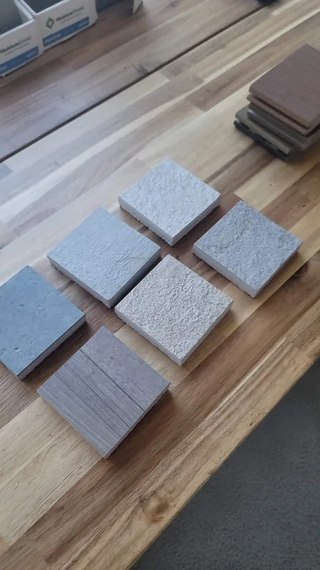 Six porcelain paver samples photographed on the City Decks office table