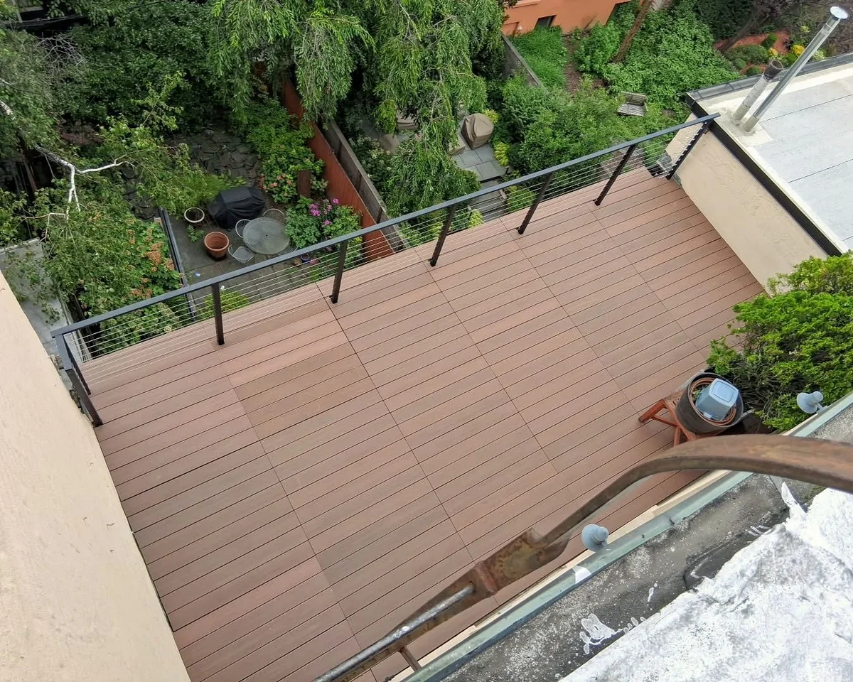 Composite terrace deck with cable railing overlooking a garden in Cobble Hill, Brooklyn
