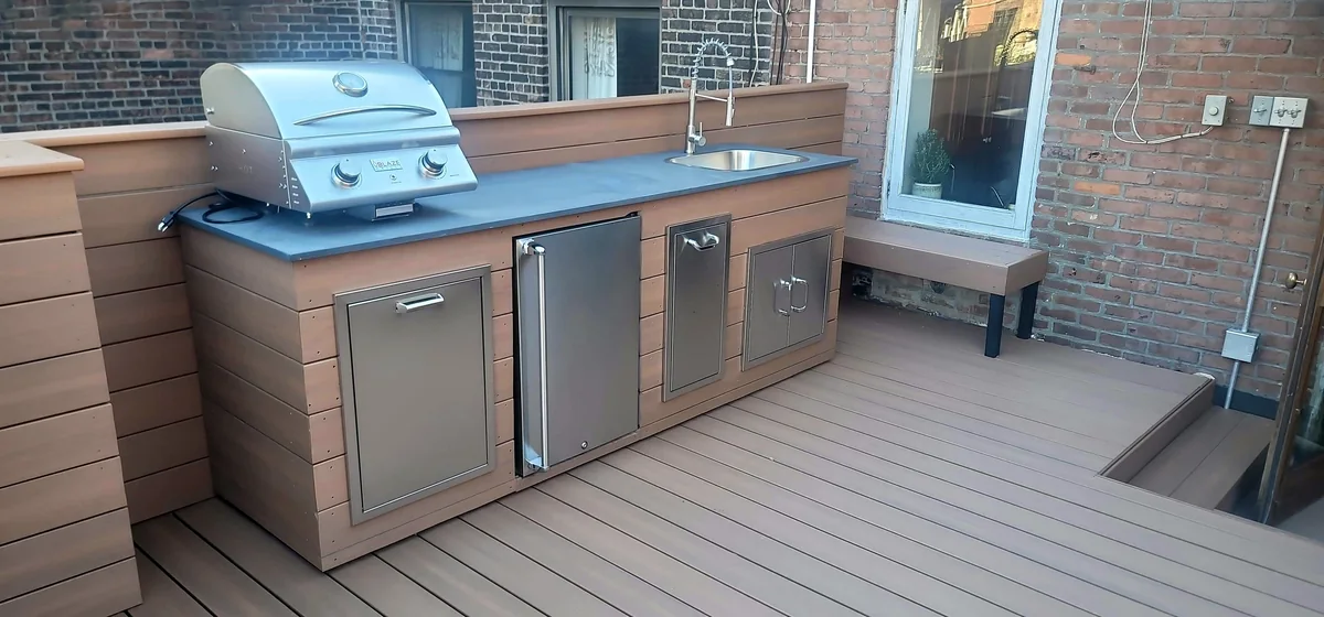 Outdoor kitchen with grill, preparation countertop and integrated storage