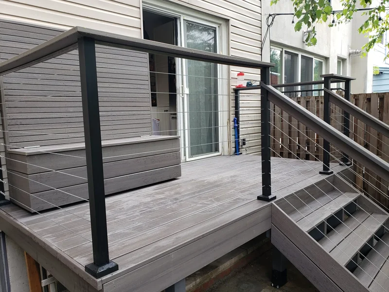 A bench, steps and cable railings connect the deck with the garden.