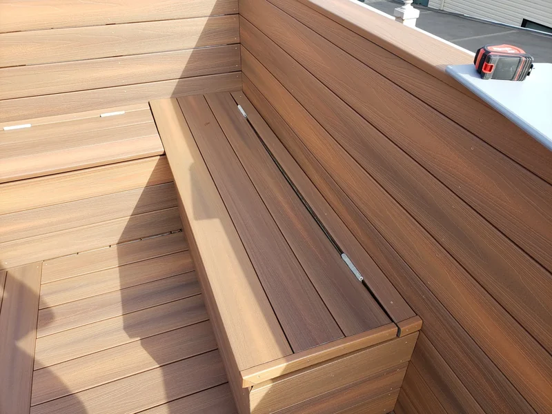 A fitted bench lid keeps storage within the finished deck design.